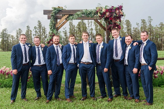 navy blue grooms attire and wedding ceremony arch for navy blue rustic elegant wedding
