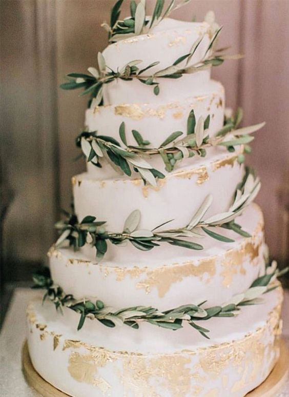 white wedding cake with greenery and glitter accents for white barn wedding colors white and sage green