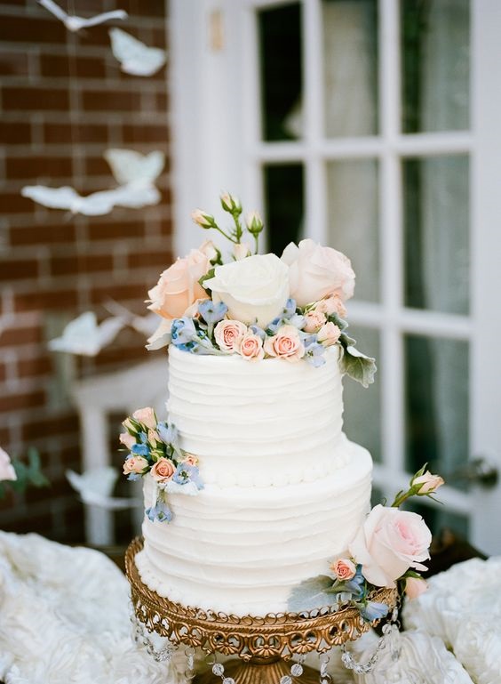 white wedding cake with blush and slate blue flowers for white barn wedding colors white slate blue and blush