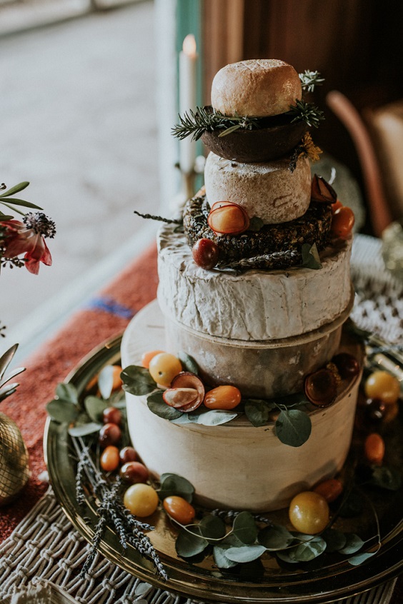 white wedding cake with fruits and greenery for white barn wedding colors dusty orange and white