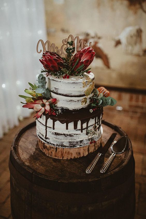 white wedding cake with maroon flowers for white barn wedding colors white and sage green