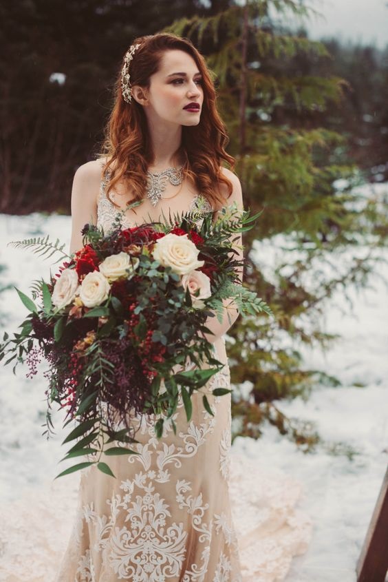 white bridal gown and red wedding bouquets for white and red outdoor winter wedding