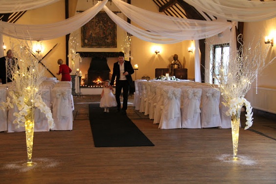 white ceremony with silver tree braches décor for winter wonderland wedding color grey and silver