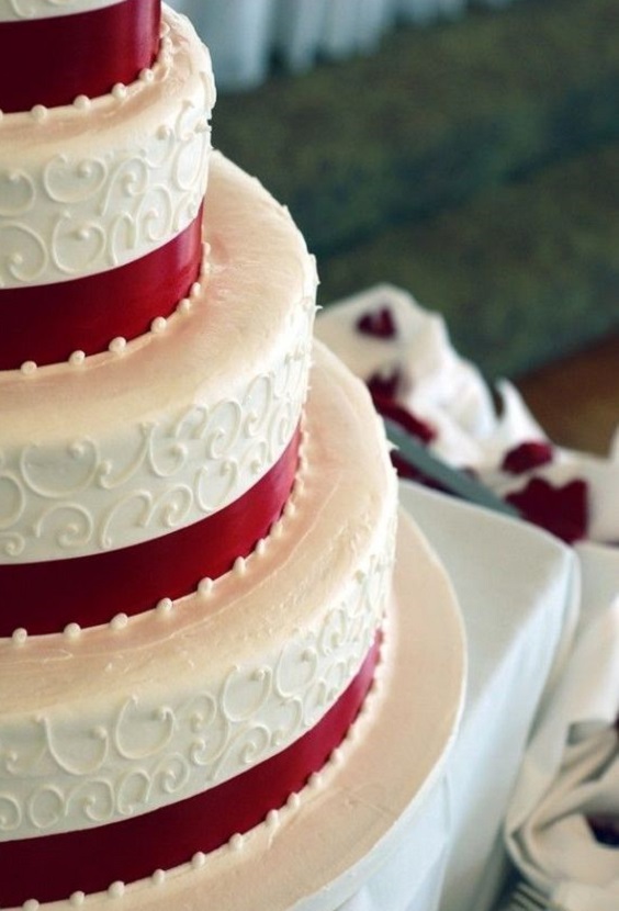 white wedding cake with red ribbons for classic red and white wedding