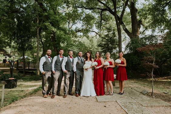 red bridesmaid dresses and white bridal gown with bouquets for simple red and white wedding
