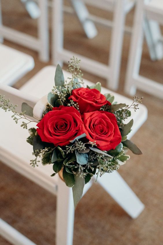 white wedding chairs with red flowers decorations for simple red and white wedding