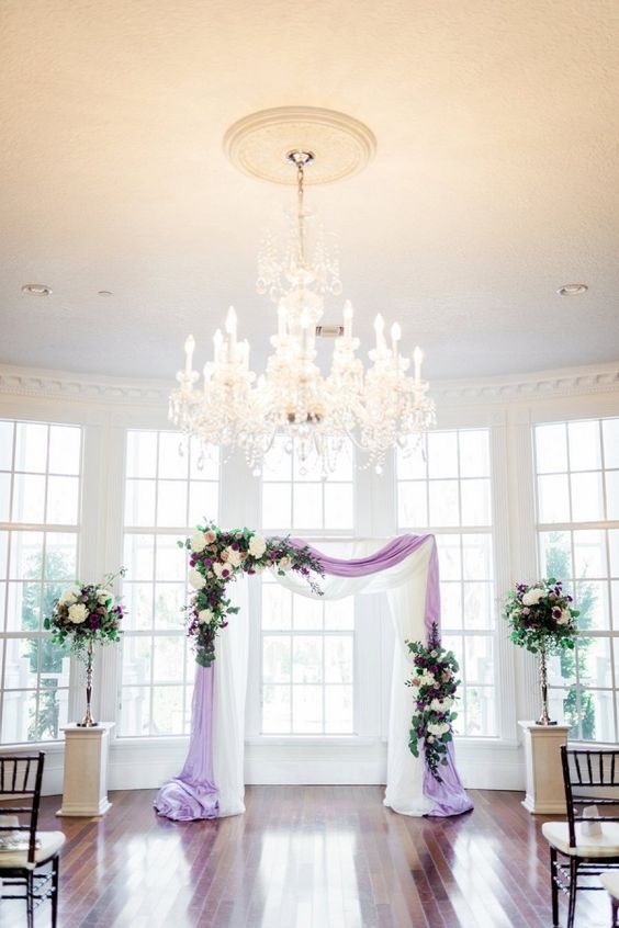 light purple wedding ceremony arch with flowers for purple green purple and blue wedding